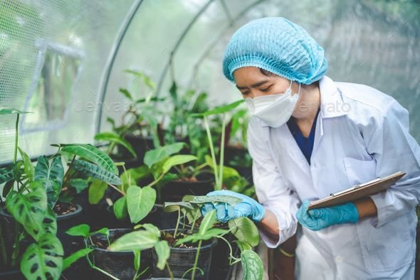 Researcher using a microscope representing biotechnology