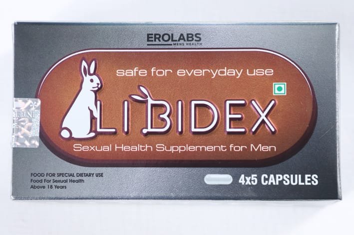 Nutraceutical supplement capsules and product packaging on a lab bench